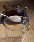 [a spooonful of sugar over a glass]